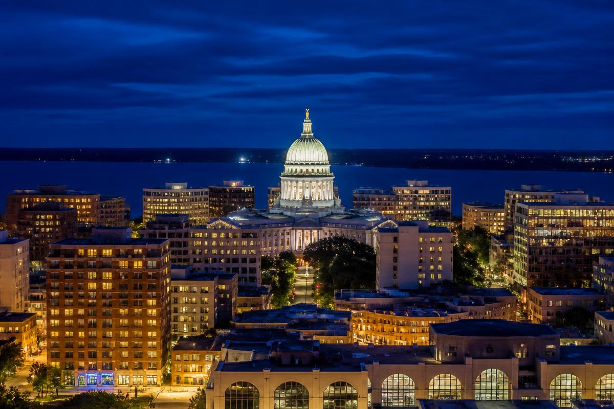 Cinematic aerial view of the Madison Wisconsin skyline at dusk with the State Capitol