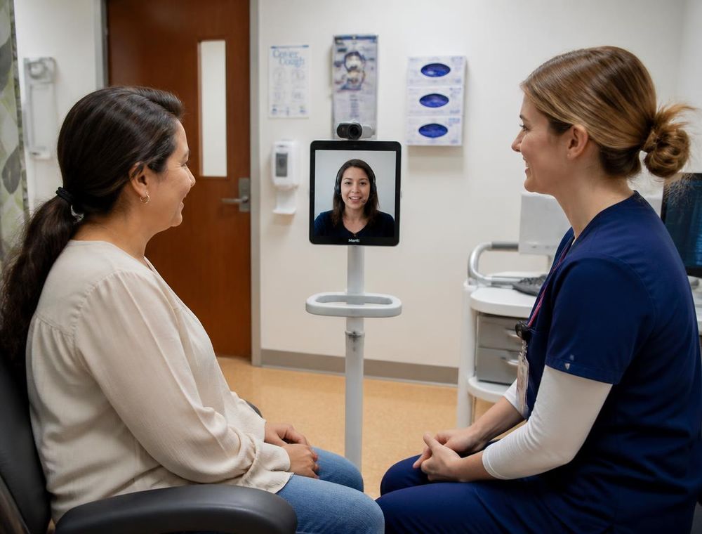 Clinician and patient speaking through a video remote interpreter on a tablet cart